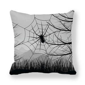 Detail of Halloween pillowcase featuring black spider web and leafless tree silhouette