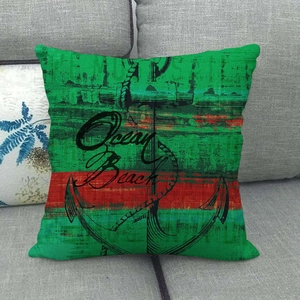 Nautical square linen pillowcase with green red stripes and anchor on gray sofa