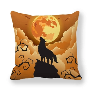 Macro detail of Halloween cushion cover with howling wolf silhouette and orange full moon
