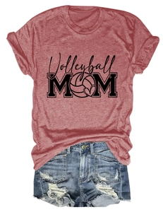Flat lay of a red Volleyball Mom t-shirt paired with distressed denim shorts on white background