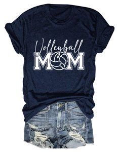 Flat lay view of a navy blue Volleyball Mom t-shirt paired with distressed denim shorts