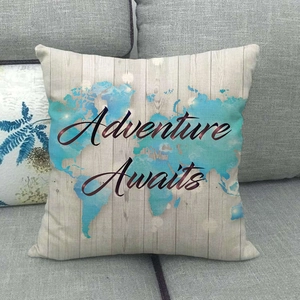 Detail of world map print and Adventure Awaits lettering on linen pillow cover