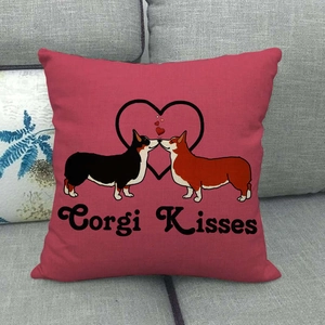 Close-up of linen pillow cover with Corgi Kisses illustration on a grey sofa
