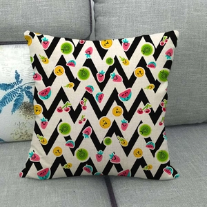 Detailed texture of linen cushion cover featuring colorful cartoon fruit patterns on a sofa