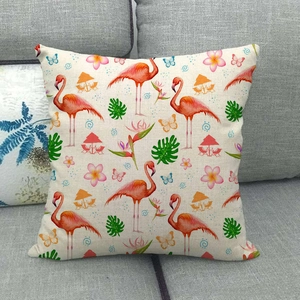 Detail of linen pillowcase featuring flamingo and tropical leaf print on sofa