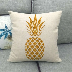 Detail of pineapple pattern on textured linen car pillow cover on a grey sofa