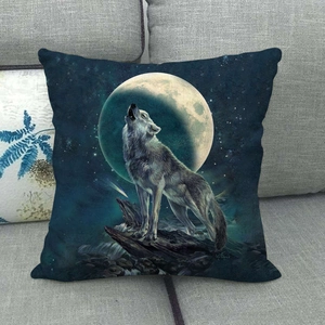 Detail of square wolf howling at the moon pillow cover on a grey sofa
