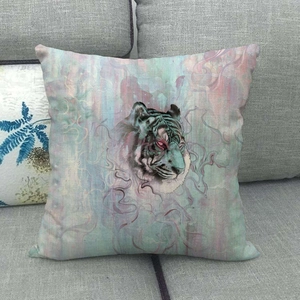 Close-up of square throw pillow with artistic tiger head print on a grey sofa fabric