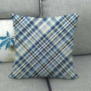 Navy and sky blue plaid linen cushion cover on a gray sofa in a home setting