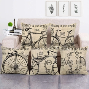 Set of five vintage bicycle linen cushion covers showing cycling history on sofa