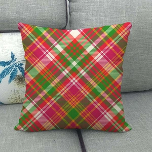 Detail of red and green tartan plaid linen pillow cover on a grey sofa