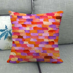Detail of linen cushion cover featuring colorful geometric watercolor brick patterns