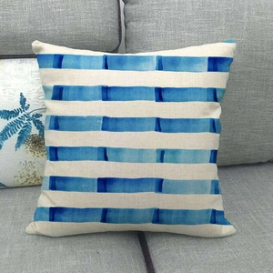 Close-up of linen cushion cover with artistic blue watercolor geometric stripes