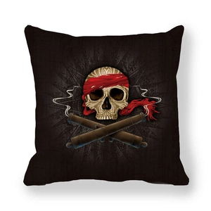 Detail of linen skull pillow cover featuring a pirate design with cannons and red bandana