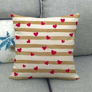 Detailed texture of linen cushion cover with brown stripes and red heart patterns