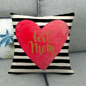 Detailed texture of linen pillowcase with red heart and THE best Mom golden text