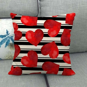 Black and white striped linen pillow cover featuring vibrant red watercolor hearts