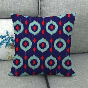 Linen decorative pillowcase featuring navy blue ikat geometric patterns on a grey sofa