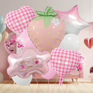 Detailed view of strawberry and heart foil balloons in a soft pink picnic party set