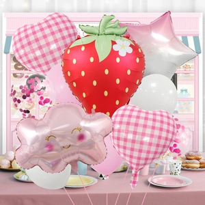 Detail of strawberry party balloon set with red foil fruit and pink heart plaid designs