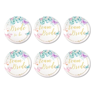 Detail view of floral Team Bride and Bride to Be tinplate badges set for weddings