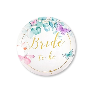 Detail of Bride to Be pin badge with watercolor butterflies and gold floral lettering