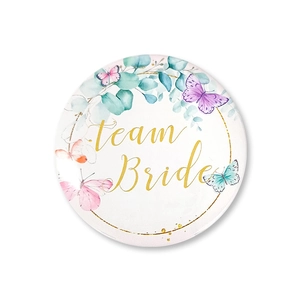 Detail of floral Team Bride tinplate badge with watercolor butterflies for wedding party