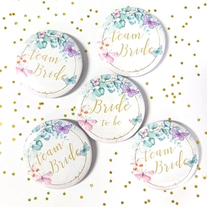 Detail of 5-piece floral Team Bride and Bride to be tinplate badges for weddings