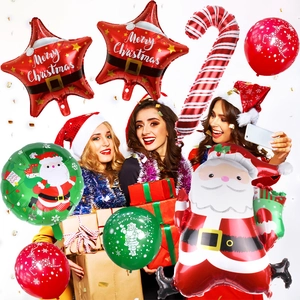 Three cheerful women with Santa hats posing with festive Christmas balloon decorations