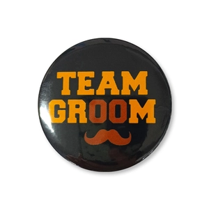 Team Groom wedding badge for groomsmen featuring orange lettering and mustache design