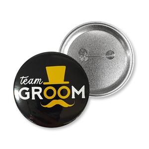 Front and back detail of 58mm team GROOM tinplate badge with pin and mustache design