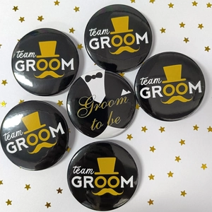 Detailed view of 6 wedding badges including Team Groom and Groom to be tinplate pins