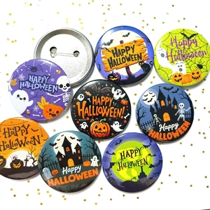 Detail showing 58mm Halloween tinplate badges with ghost and pumpkin designs and back pin