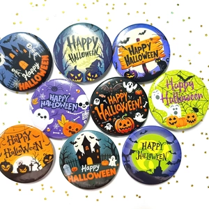 Set of nine 58mm tinplate Halloween badges featuring pumpkins, ghosts, and bat designs
