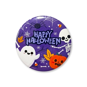 Detailed view of a purple 58mm Halloween tinplate badge with ghost and pumpkin designs