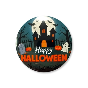 Close-up of a 58mm tinplate Halloween party badge with castle and pumpkin designs