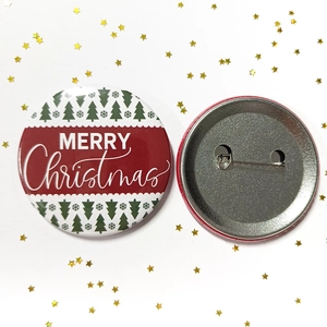 Close-up of 58mm Merry Christmas tinplate badge showing both front and pin back views