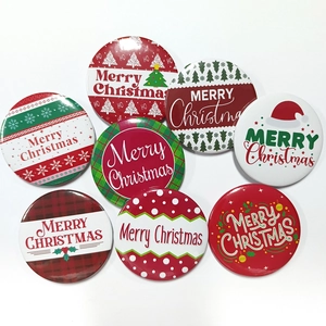 Detailed flat lay of 8 assorted tinplate Christmas badges with festive plaid and tree designs
