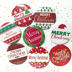 Close-up of 8 Christmas tinplate badges with various festive patterns and Merry Christmas text