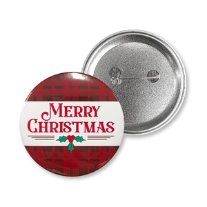 Close-up of 58mm Christmas tinplate badges with buffalo plaid design and safety pin back