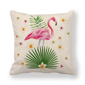 Detail of pink flamingo and palm leaf print on textured linen cushion cover