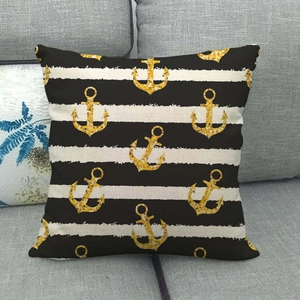 Detail of nautical pillow cover featuring gold sequin anchor on black and white stripes