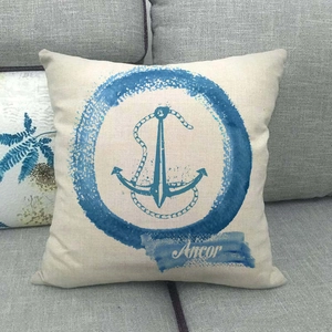 Close-up of anchor print and woven linen texture on a square nautical throw pillow