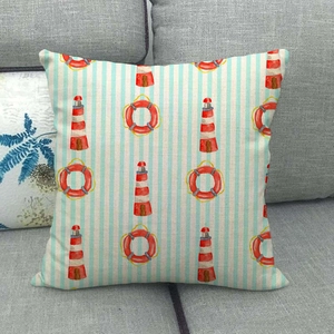 Coastal nautical cushion cover with lighthouse and lifebuoy print on striped fabric