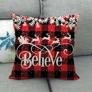 Détail de la housse de coussin de Noël à carreaux rouges et noirs avec lettrage Believe
