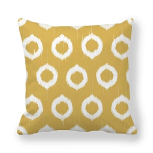 Detail of mustard yellow geometric cushion cover with white ikat circle pattern