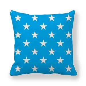 Detail of light blue peach skin cushion cover with white star pattern and soft texture