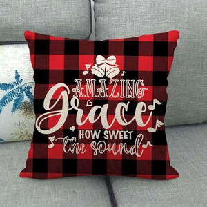Detail of red and black buffalo plaid pillow cover with Amazing Grace printed text