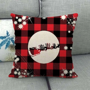 Detailed texture of red and black buffalo plaid Christmas pillow cover on a sofa