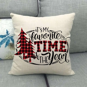 Christmas plaid tree linen pillow cover with festive typography on a gray sofa